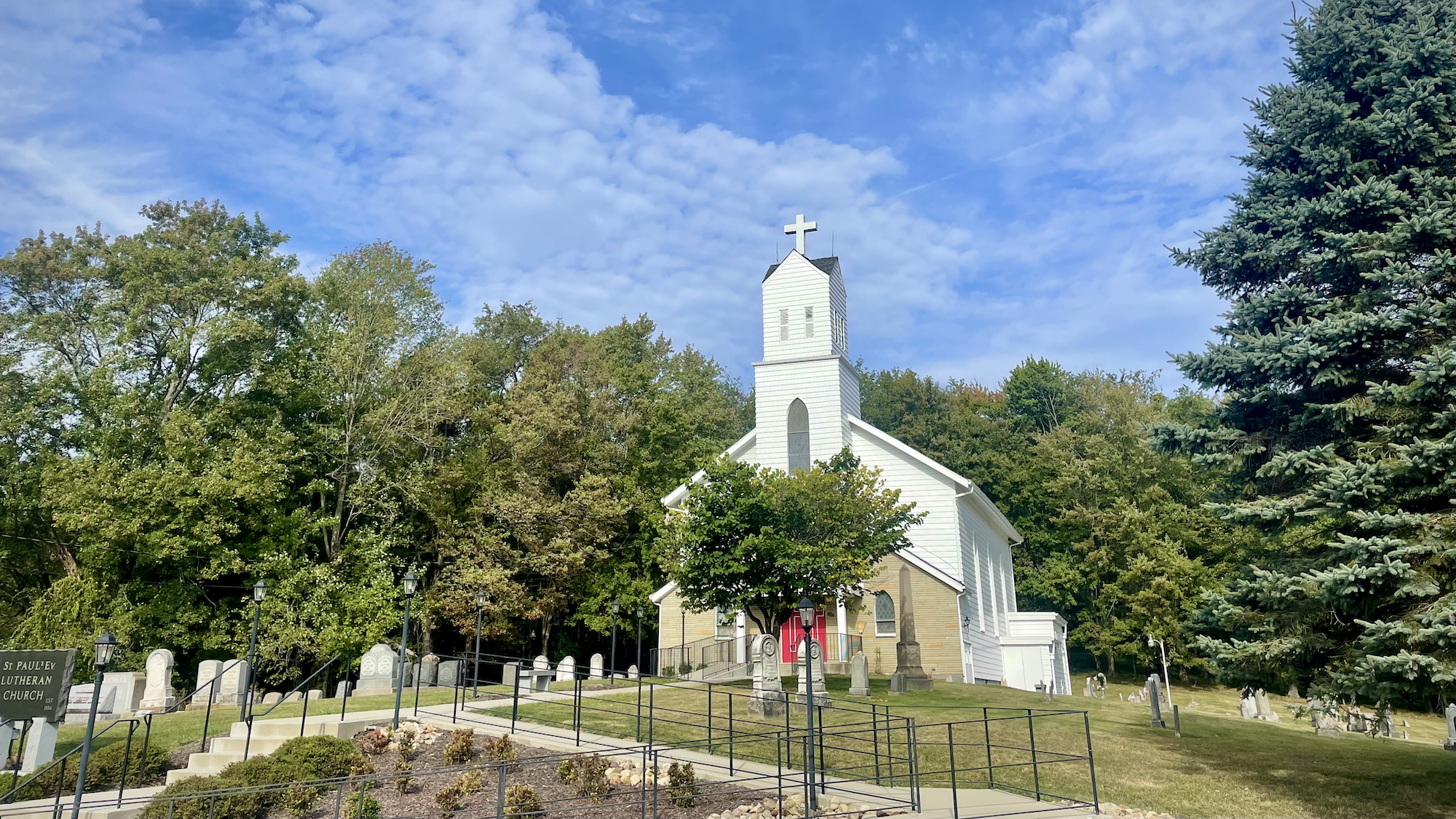 A church on a hill with gravestones in the foreground